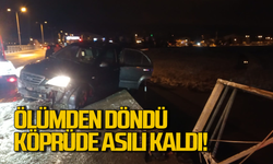 Otomobil buzlu yolda kontrolü kaybetti, köprüde asılı kaldı