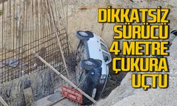 Dikkatsiz sürücü 4 metrelik çukura uçtu